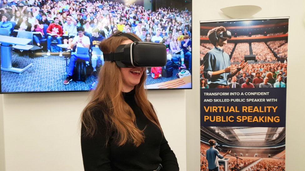 Students smiling, while wearing a VR headset
